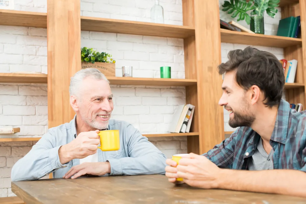 Home carer and client sharing tea during an hourly home care visit in London